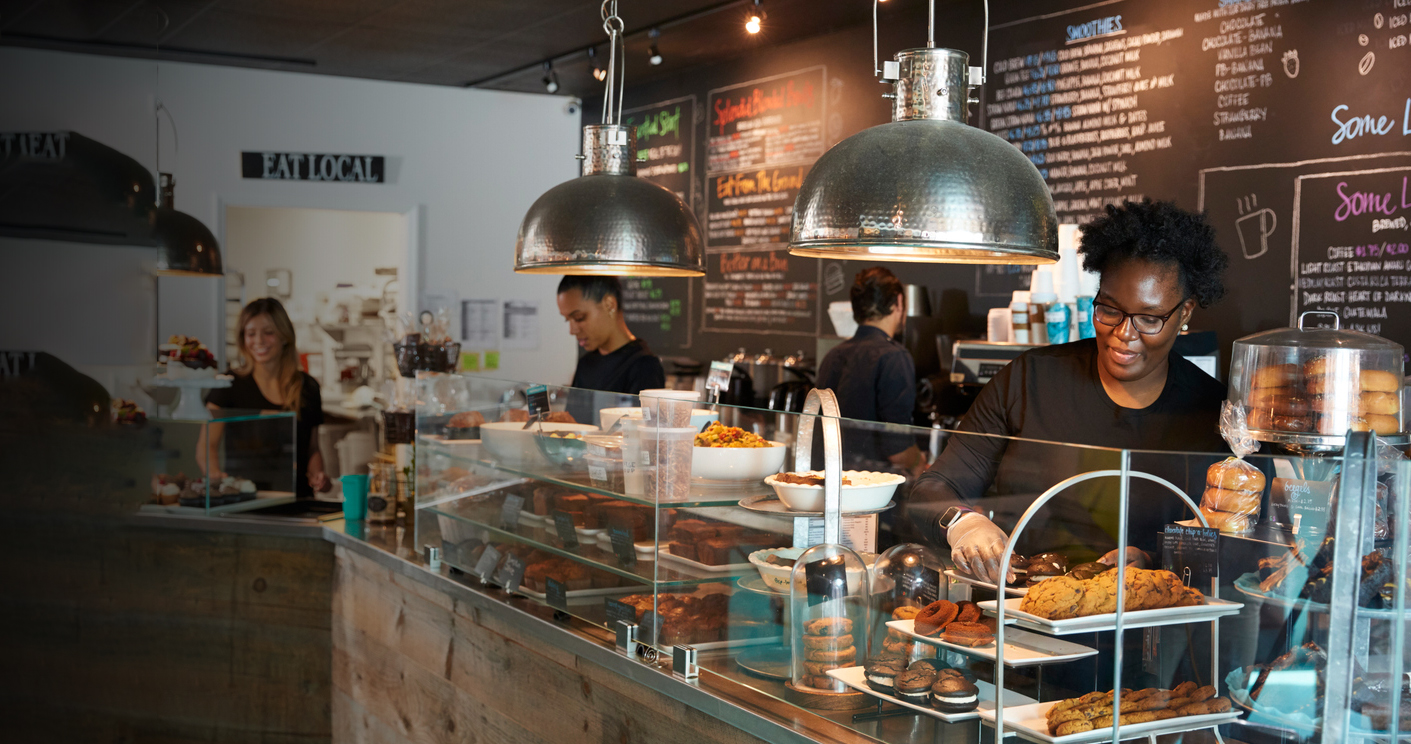 Food and beverage team serving customers at a modern cafe