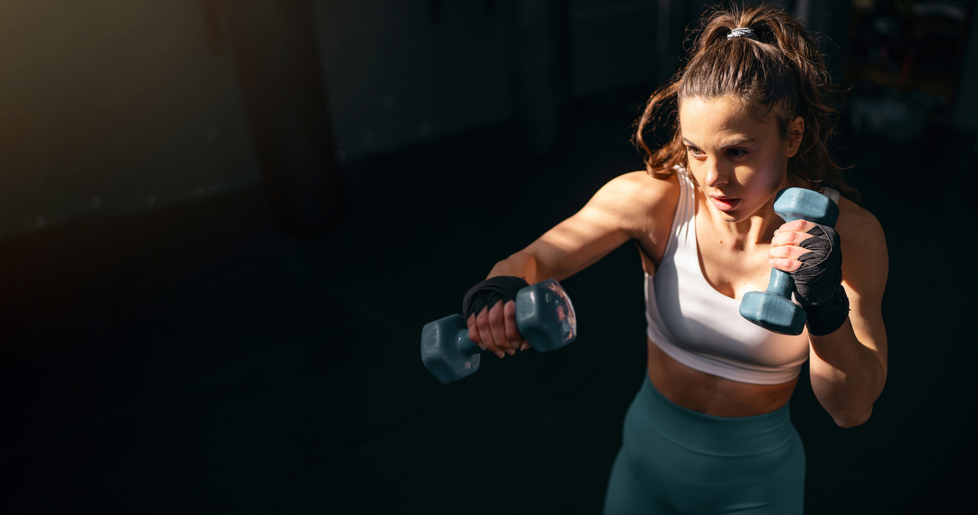 Athlete training with dumbbells in a modern fitness studio