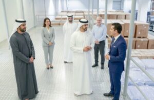 UAE business leaders discussing local industry inside a warehouse as part of the ICV certification process.