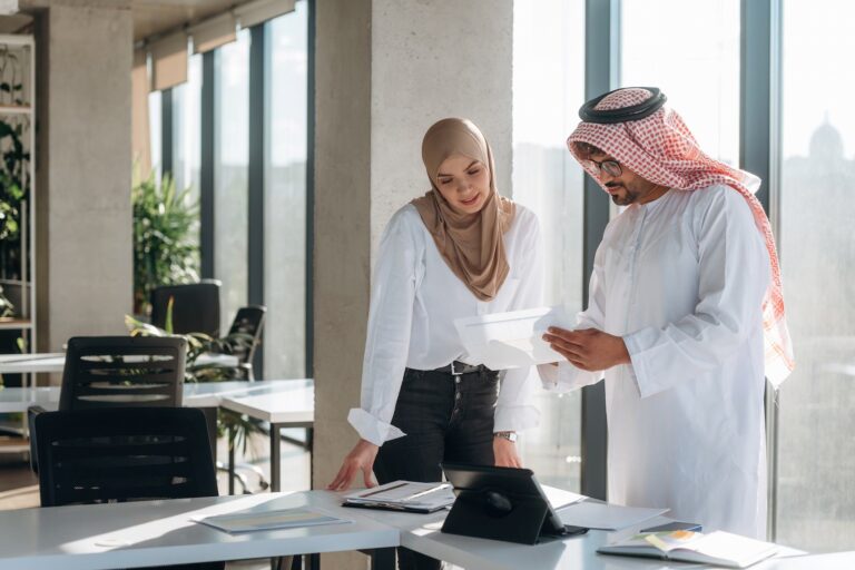 Business consultants reviewing documents for a professional licence in Dubai.