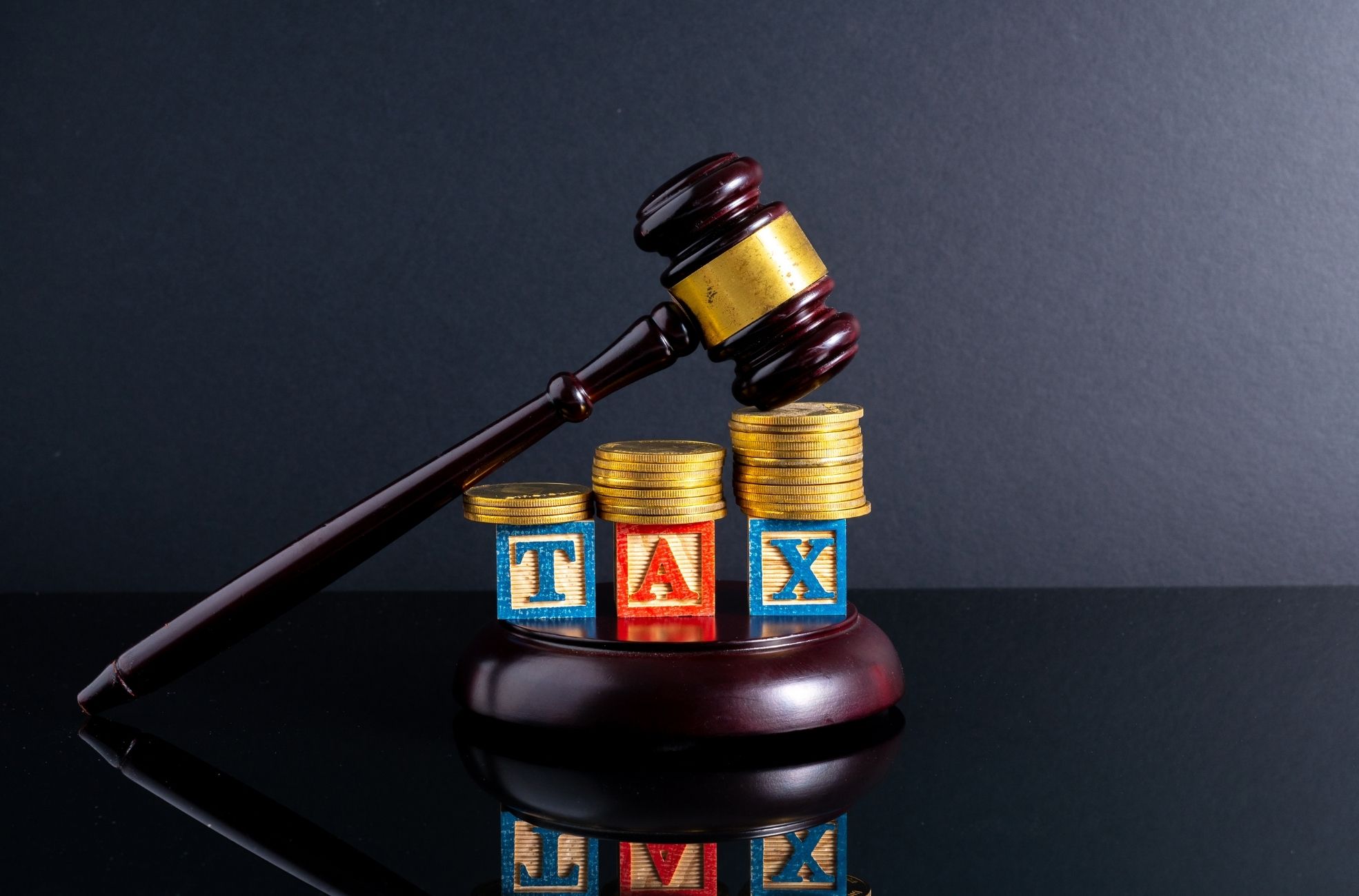 A Gavel Over Coins And Blockings Spelling TAX