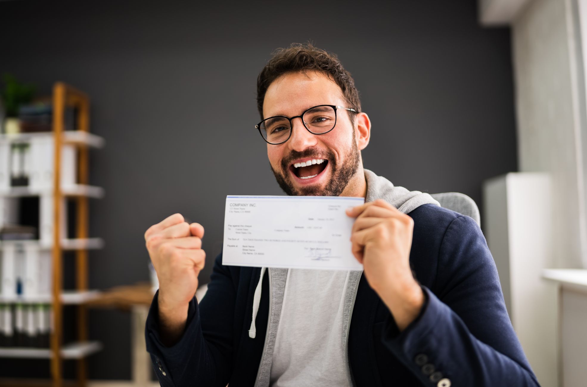 Happy Employee With His Payroll Slip