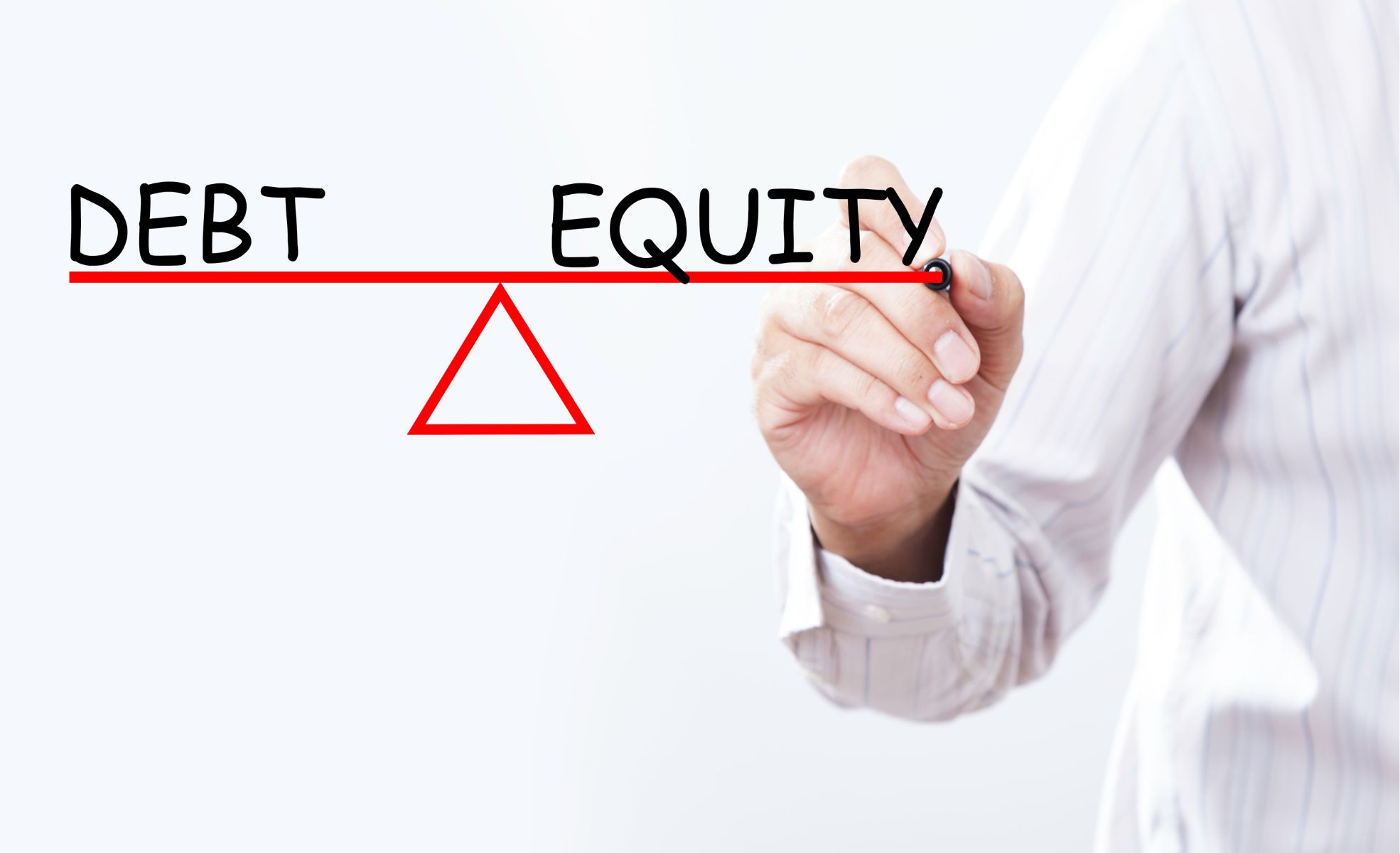 Man Balancing Debt Vs Equity On Whiteboard