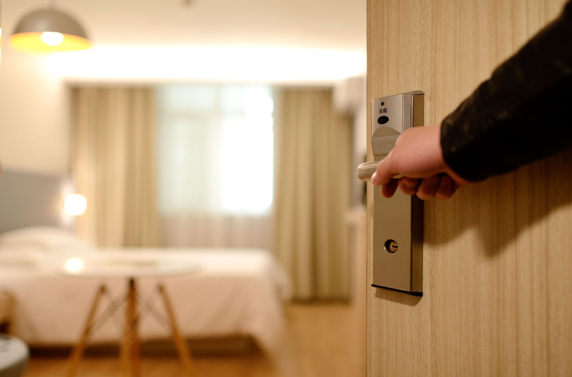 Man Opening Hotel Room Door