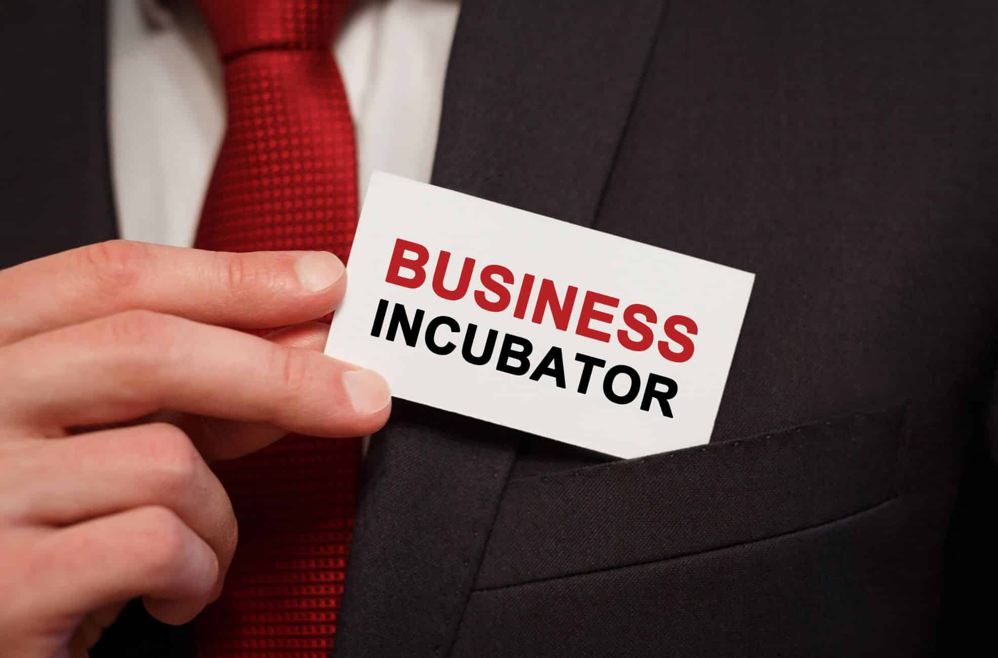 Man Holding Business Card Saying "Business Incubator"