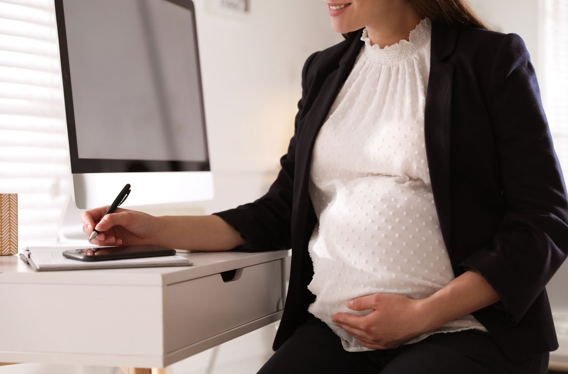 Pregnant Woman Working In Office