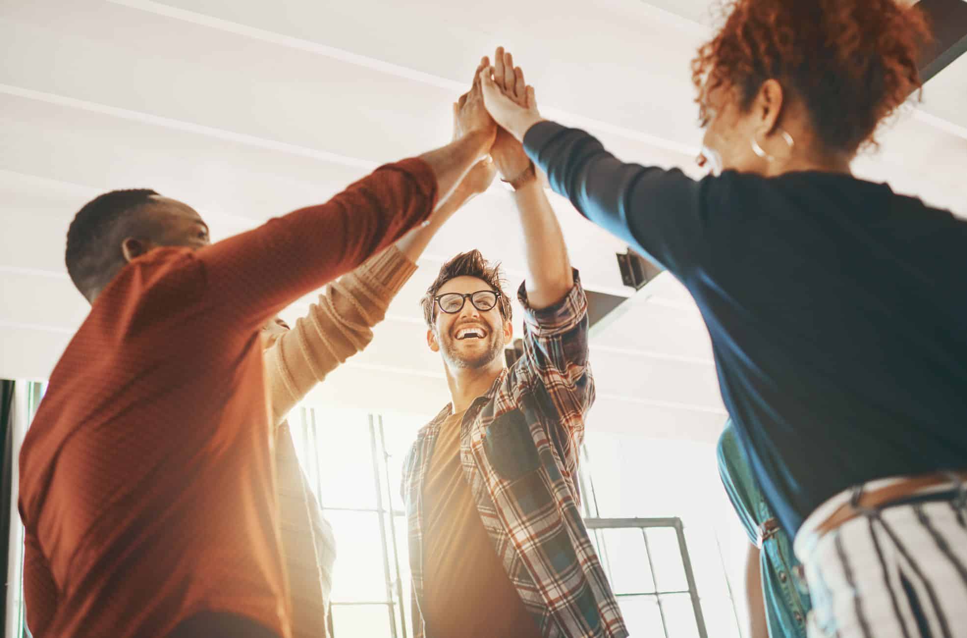 Workmates High-Fiving For Collaborative Celebration