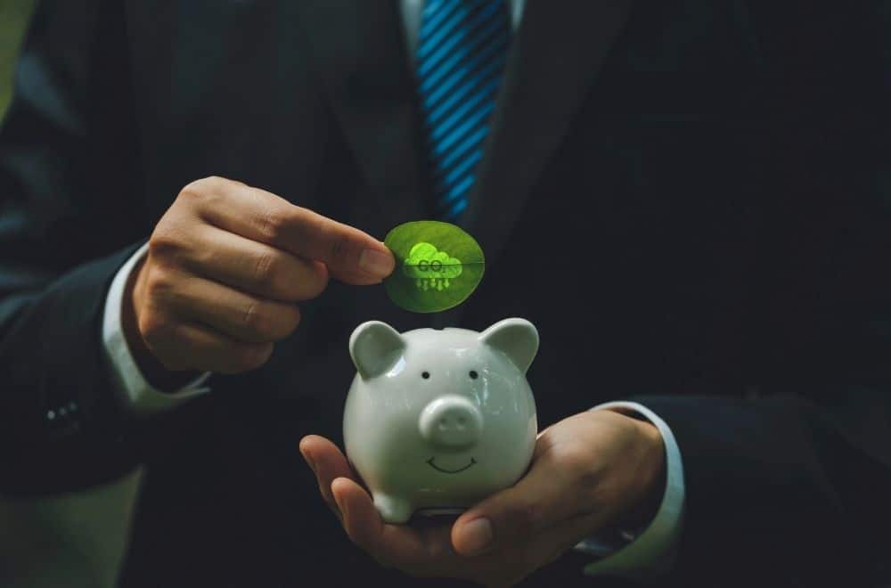 Carbon Trading Shown With Piggy Bank And Businessman