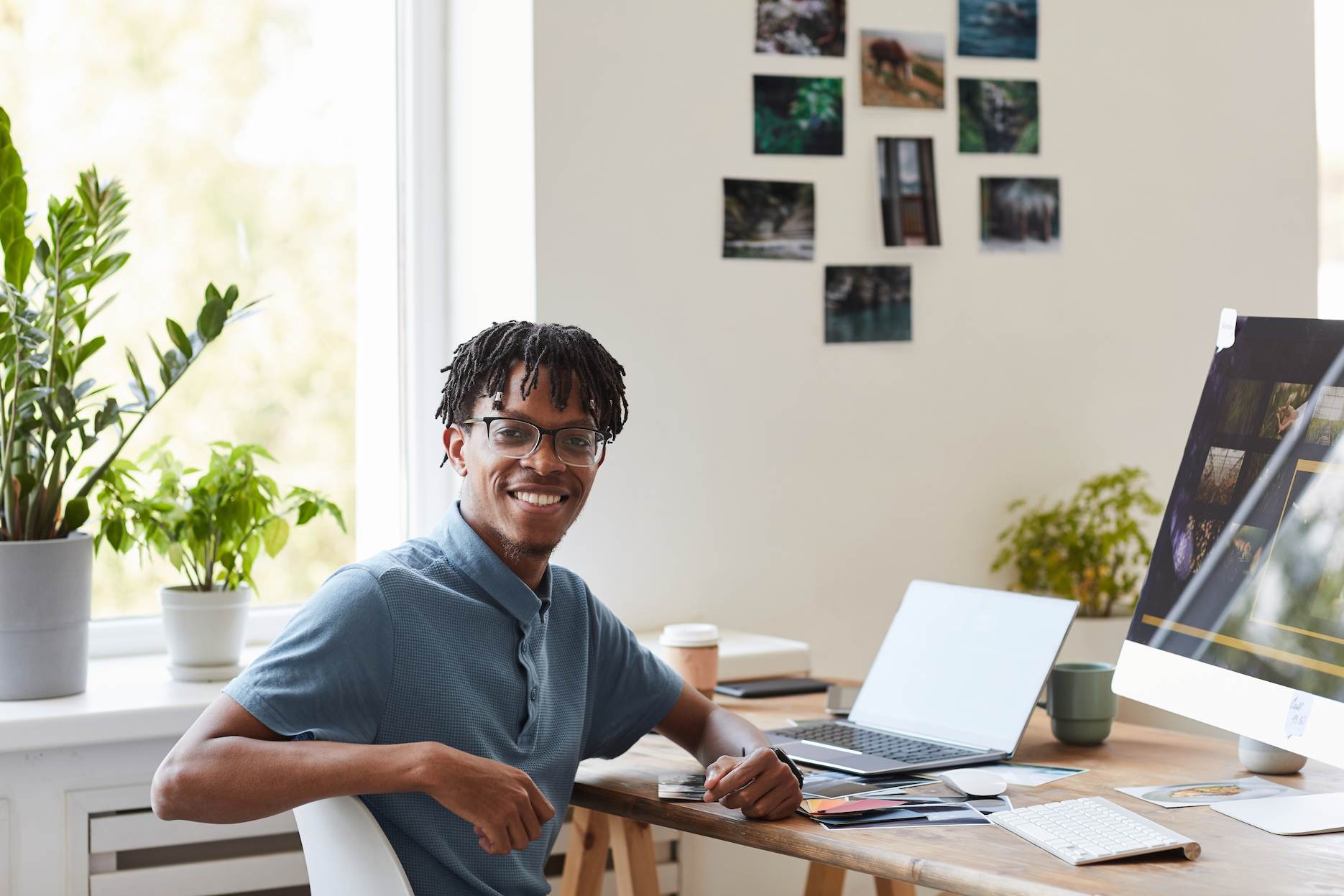 Home-based entrepreneur working at a desk with a laptop in a professional home office setup.