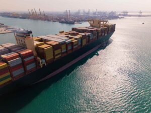 Container ship arriving at a Dubai port for import and export cargo clearance.