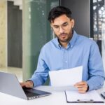 UAE business owner reviewing a VAT tax invoice.