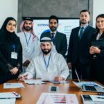 Multiethnic business professionals meeting in a modern Dubai office.